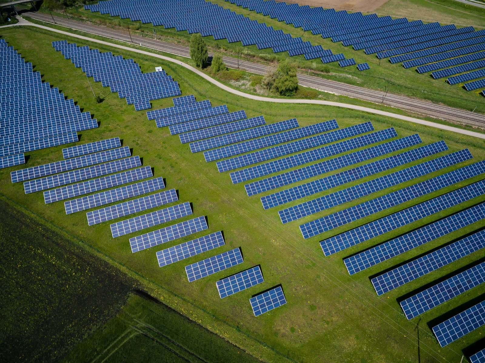 Aerial view of a large solar farm beside a reservoir